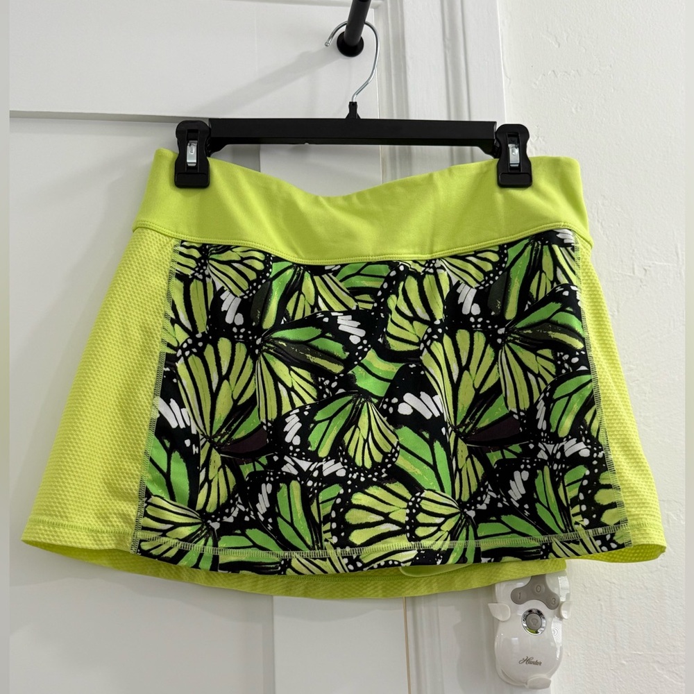 Fila neon yellow green mini skort w/ multicolor butterfly pattern